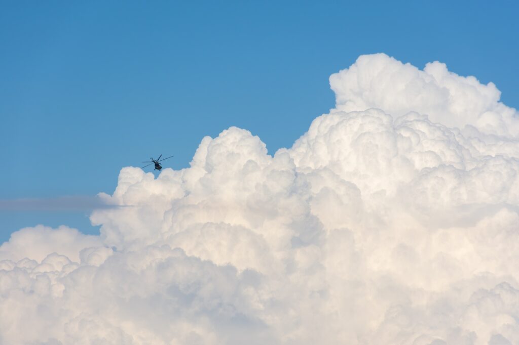 Helicopter cumulus clouds. The concept of aircraft flight safety.