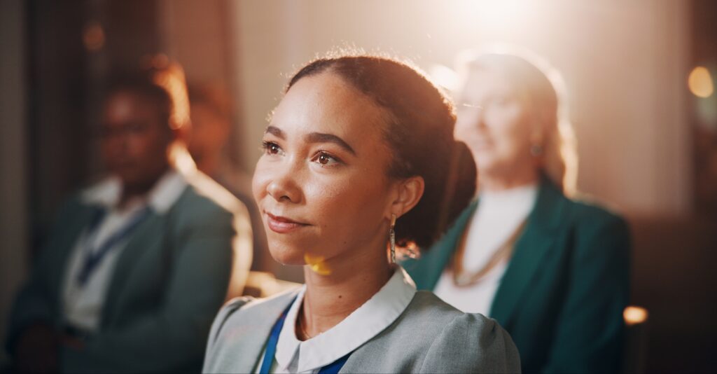 Woman, thinking or crowd in seminar for business, employee engagement or campaign information. Staf